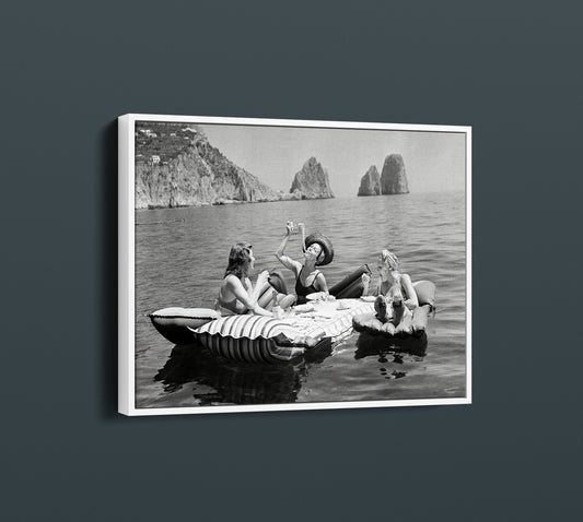 Floating Luncheon Canvas Wall Art | Three young women eat spaghetti on inflatable mattresses at Lake of Capri 1939 - PPL11